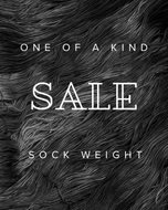Text 'One of a Kind Sale Sock Weight' on a textured black and white background