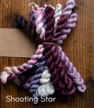 Load image into Gallery viewer, Bundled yarn skeins in purple, pink, and white on a wooden surface with 'Shooting Star' text.