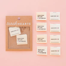 Load image into Gallery viewer, Packaging of 'Made with Love' labels by Sarah Hearts on a pink background
