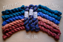 Load image into Gallery viewer, Three skeins of yarn in blue, pink, and purple on a wooden surface with text labels.
