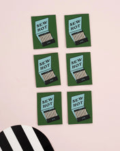 Load image into Gallery viewer, Six 'Sew Hot' matches packaging on a light pink background with a black and white striped object.