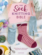 Book titled 'The Sock Knitting Bible' with knitted socks and yarn on a wooden surface.