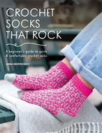 Book cover of 'Crochet Socks That Rock' by Anna Nikipirowicz with pink crochet socks on a blurred background.