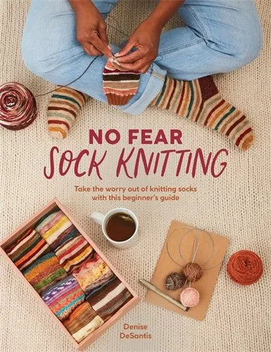Book cover of 'No Fear Sock Knitting' with colorful socks and knitting materials on a textured surface.