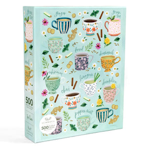 Puzzle box with tea-themed design featuring various teacups and tea leaves on a light blue background.