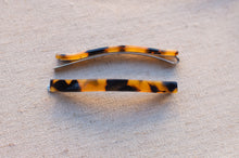 Load image into Gallery viewer, Two tortoiseshell hair clips on a textured beige surface