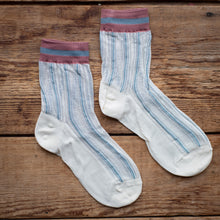 Load image into Gallery viewer, Pair of white socks with blue stripes on a wooden surface