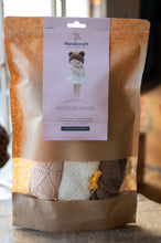 Load image into Gallery viewer, Crochet kit packaging with a visible brand label on a wooden surface.