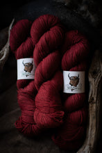 Load image into Gallery viewer, three maroon skeins of yarn with rustic background