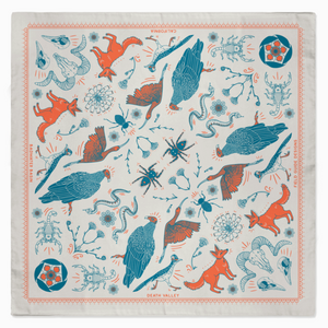 Patterned fabric with fox and bird design on a white background