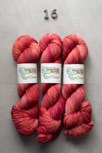 Load image into Gallery viewer, Three skeins of red yarn with labels on a gray background