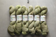 Five skeins of green yarn with labels on a gray background