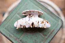 Load image into Gallery viewer, Marble-patterned hair clip on a green metal surface