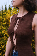 Load image into Gallery viewer, Woman wearing a brown sleeveless top with a yellow flower background