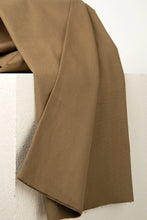 Load image into Gallery viewer, Brown fabric draped over a white surface