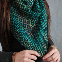 Load image into Gallery viewer, Person wearing a green and blue patterned scarf against a gray background