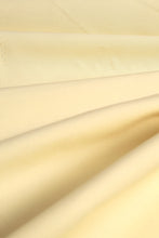 Load image into Gallery viewer, Close-up of beige fabric with folds