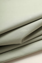 Load image into Gallery viewer, Close-up of light green fabric with folds on a matching background