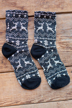 Load image into Gallery viewer, Pair of socks with deer pattern on a wooden surface