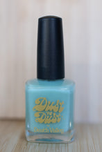 Load image into Gallery viewer, Nail polish bottle with black cap and blue liquid, featuring &#39;Dust to Dust&#39; branding.