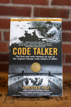 Load image into Gallery viewer, Book titled 'Code Talker' by Chester Nez on a wooden surface with a brick wall background