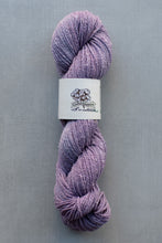 Load image into Gallery viewer, Purple skein of yarn with a label on a gray background