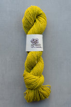 Load image into Gallery viewer, Yellow skein of yarn with a label on a gray background