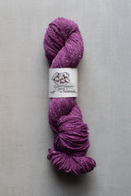Load image into Gallery viewer, Purple skein of yarn with a label on a gray background