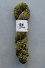 Load image into Gallery viewer, Green skein of yarn with a label on a gray background