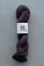 Load image into Gallery viewer, Purple skein of yarn with a label on a gray background