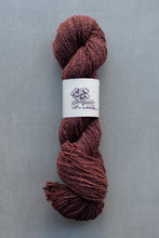 Load image into Gallery viewer, Ball of brown yarn with a label on a gray background