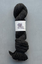 Load image into Gallery viewer, Ball of dark gray yarn with a label on a gray background