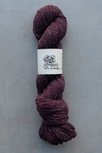 Load image into Gallery viewer, Ball of purple yarn with a label on a gray background