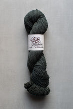 Load image into Gallery viewer, Gray skein of yarn with a label on a gray background