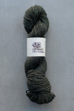 Load image into Gallery viewer, Gray skein of yarn with a label on a gray background