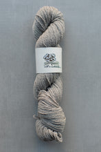 Load image into Gallery viewer, Gray skein of yarn with a label on a gray background