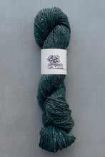 Load image into Gallery viewer, Green skein of yarn with a label on a gray background