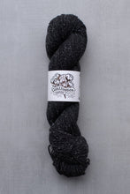 Load image into Gallery viewer, Dark gray skein of yarn with a label on a light gray background