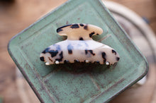 Load image into Gallery viewer, Tortoiseshell patterned hair clip on a green metal surface