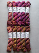 Load image into Gallery viewer, Six skeins of multicolored yarn with labels on a gray background