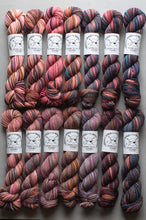 Load image into Gallery viewer, Set of skeins of multicolored yarn with labels on a neutral background