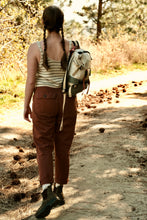 Load image into Gallery viewer, Person walking on a dirt path in a forest with a backpack