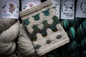 Knitted item with yarn and Spincycle Yarns branding in the background