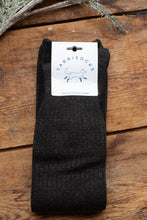 Load image into Gallery viewer, Black sock with Tabbisocks label on a wooden surface