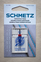 Load image into Gallery viewer, Schmetz topstitch twin needle packaging on a textured fabric background