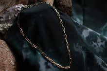 Load image into Gallery viewer, Gold chain necklace on a dark fabric background