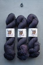 Load image into Gallery viewer, Three skeins of dark yarn with labels on a gray background