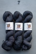 Load image into Gallery viewer, Three skeins of dark gray yarn with a branded label on a gray background