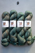 Load image into Gallery viewer, Four skeins of green yarn with labels on a gray background