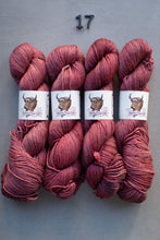 Load image into Gallery viewer, Four skeins of red yarn with labels on a gray background